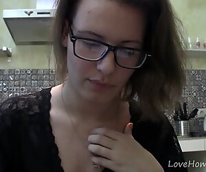 Solo girl with glasses chatting in the kitchen